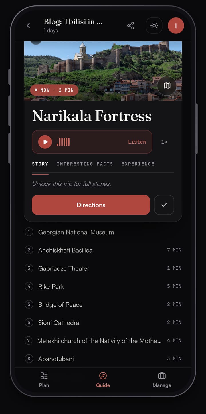 Passage AI Guide card for Narikala Fortress with a photo of the fortress walls above Old Tbilisi, a Listen button, Story, Interesting facts and Experience tabs, a Directions button and the rest of the day's stops below